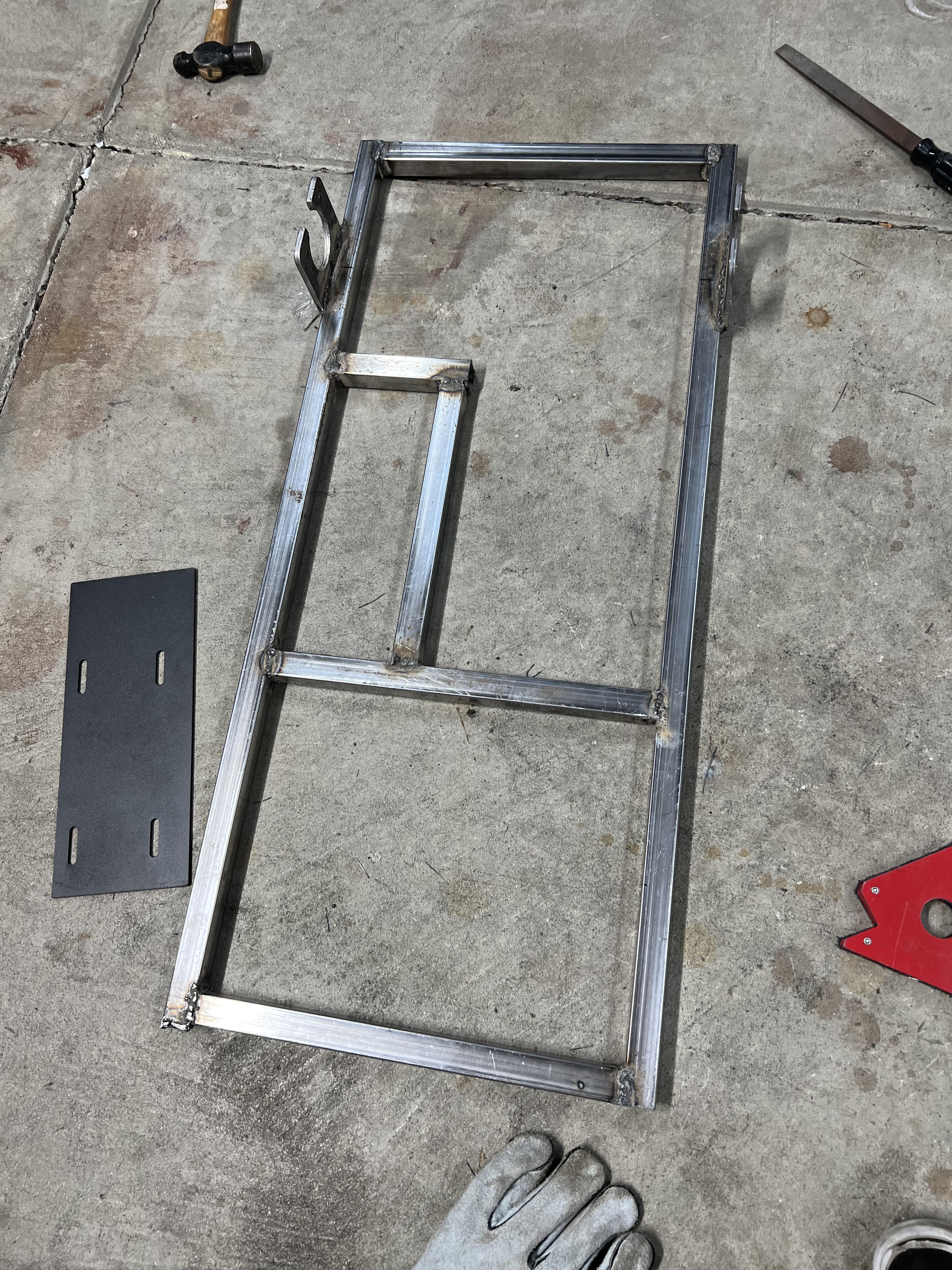 Welded chassis frame section on the garage floor